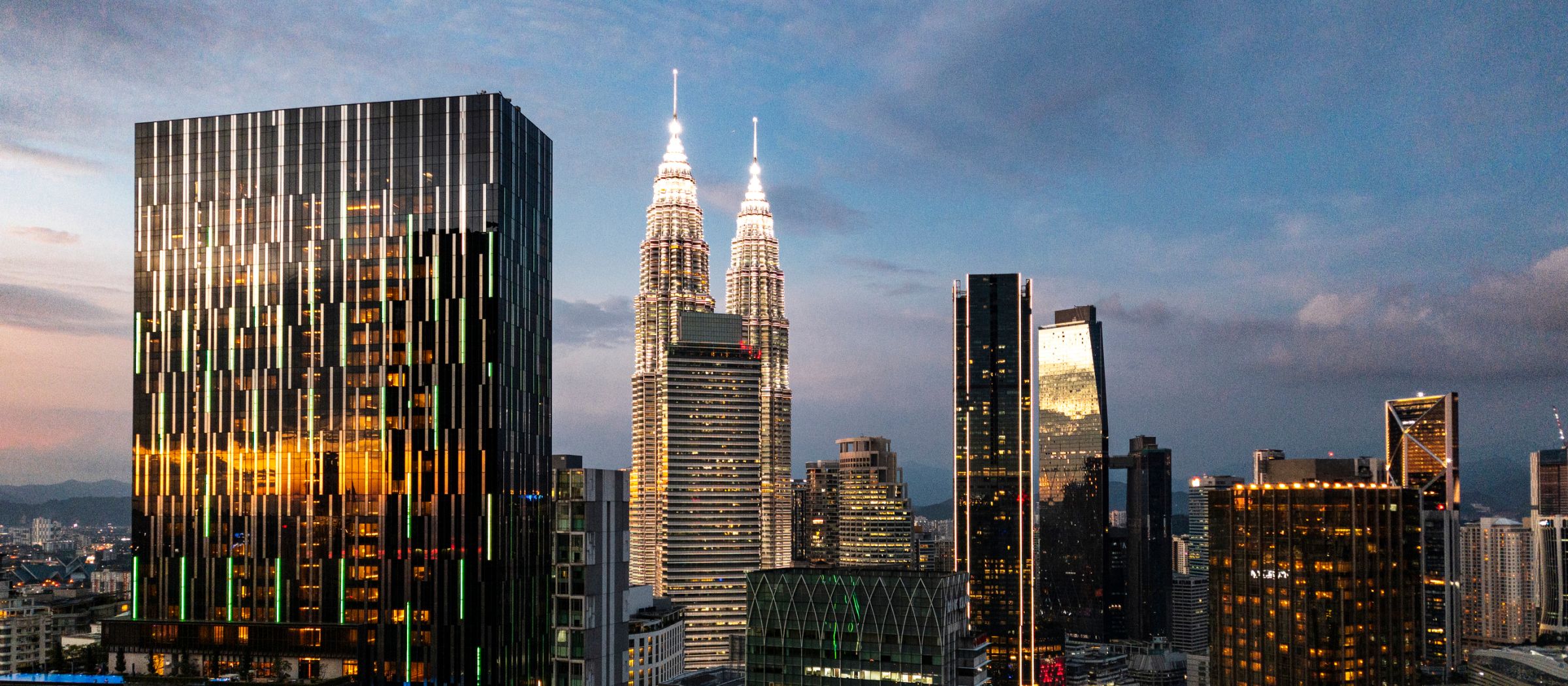 Kuala Lumpur skyline at dusk, with the Petronas Twin Towers